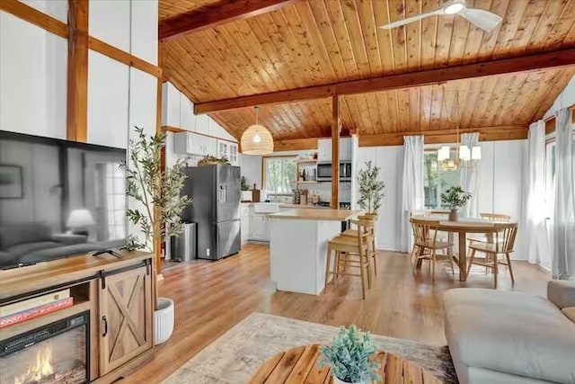 kitchen featuring stainless steel appliances, plenty of natural light, wood ceiling, and light wood-style flooring