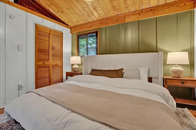 bedroom with wooden ceiling, wood finished floors, a closet, and lofted ceiling