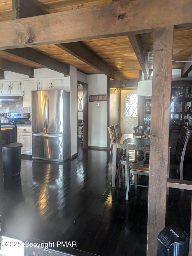 dining space with dark wood-type flooring, wood ceiling, beam ceiling, and baseboards