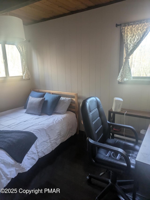 bedroom featuring wood ceiling and multiple windows