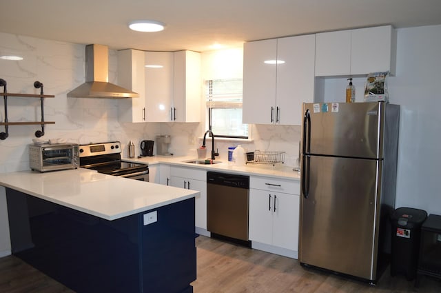 6372 Baltic Ave, Tobyhanna, PA 18466 - kitchen with stainless steel appliances, wall chimney exhaust hood, a sink, a peninsula, and tasteful backsplash