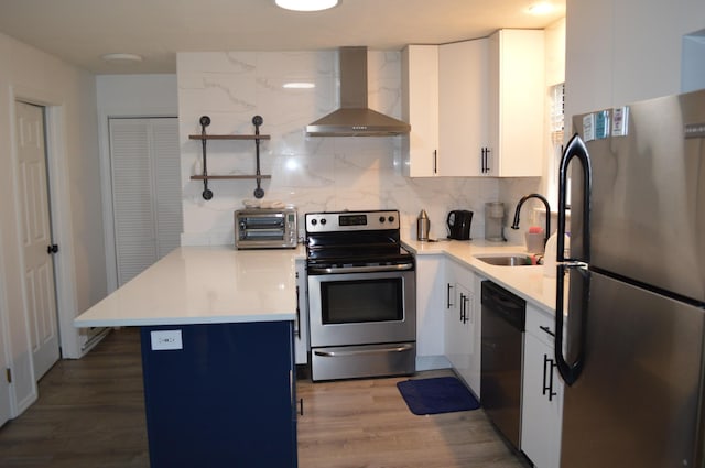 6372 Baltic Ave, Tobyhanna, PA 18466 - kitchen with wall chimney exhaust hood, appliances with stainless steel finishes, a sink, a peninsula, and open shelves