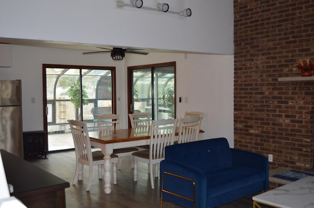 6372 Baltic Ave, Tobyhanna, PA 18466 - dining area with a ceiling fan, wood finished floors, and brick wall