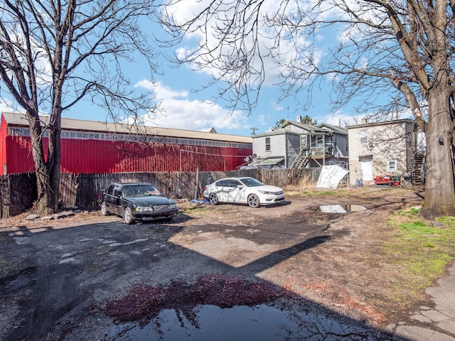 view of yard featuring stairs and fence