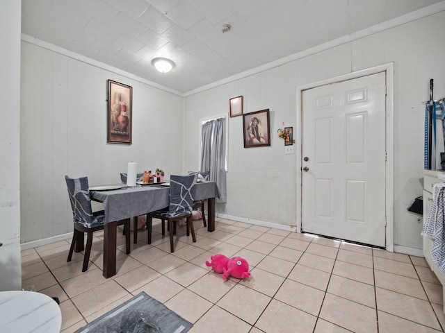 dining area featuring baseboards, light tile patterned floors, and ornamental molding
