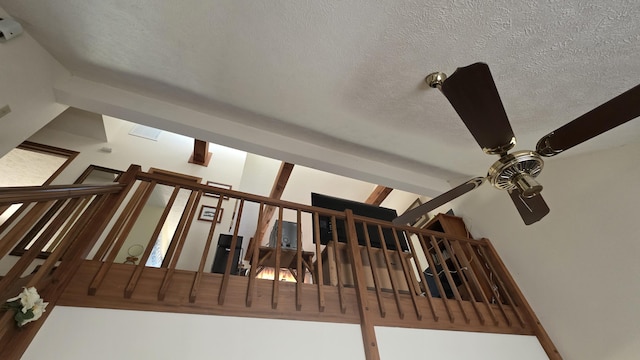 details featuring a ceiling fan and a textured ceiling
