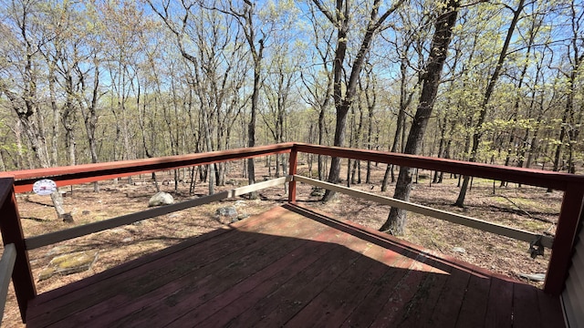 wooden deck featuring a view of trees