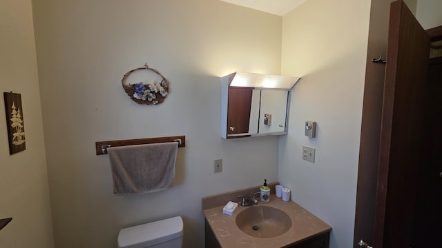 bathroom featuring toilet and vanity