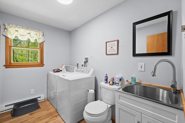 126 Keystone Ln, Tobyhanna, PA 18466 - bathroom featuring baseboard heating, washing machine and clothes dryer, wood finished floors, toilet, and vanity