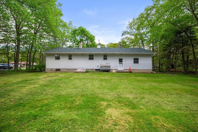126 Keystone Ln, Tobyhanna, PA 18466 - back of house featuring a lawn, a chimney, and heating fuel
