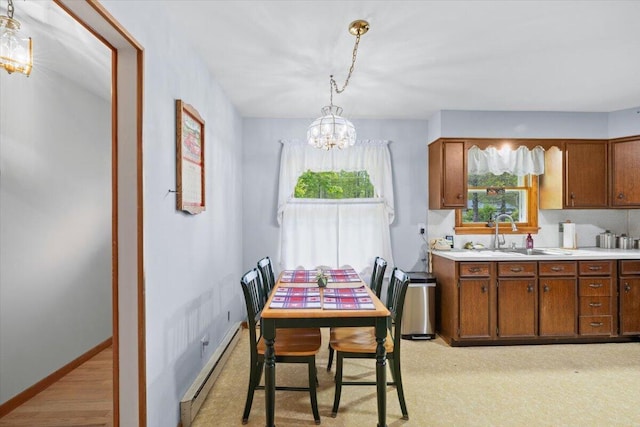 126 Keystone Ln, Tobyhanna, PA 18466 - dining room featuring a baseboard heating unit, a chandelier, and baseboards