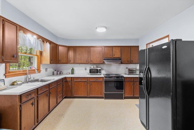 126 Keystone Ln, Tobyhanna, PA 18466 - kitchen featuring black appliances, a sink, under cabinet range hood, and brown cabinetry