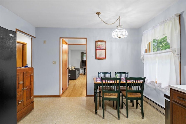 126 Keystone Ln, Tobyhanna, PA 18466 - dining space with a chandelier, a baseboard heating unit, and baseboards