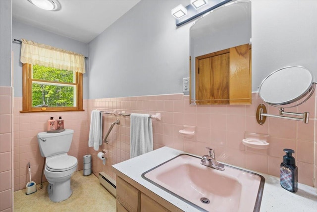 126 Keystone Ln, Tobyhanna, PA 18466 - bathroom with a baseboard radiator, tile walls, toilet, vanity, and wainscoting