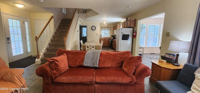 tiled living room featuring stairway