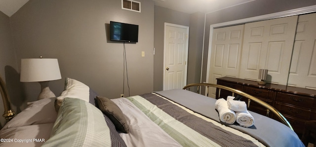 bedroom with a closet and visible vents