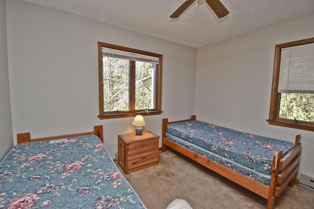 248 Miller Dr, Pocono Pines, PA 18350 - carpeted bedroom featuring ceiling fan, a textured ceiling, and a baseboard radiator