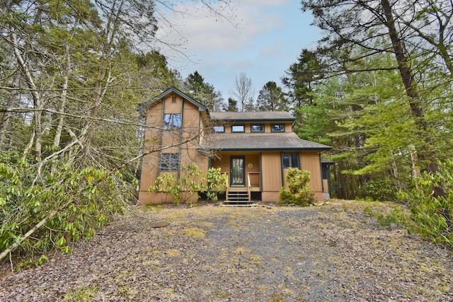 248 Miller Dr, Pocono Pines, PA 18350 - chalet / cabin featuring a shingled roof and covered porch
