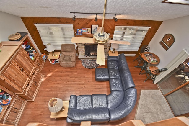 248 Miller Dr, Pocono Pines, PA 18350 - living area with wooden walls, wood finished floors, rail lighting, and a textured ceiling