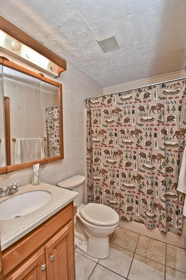 248 Miller Dr, Pocono Pines, PA 18350 - full bathroom with a textured ceiling, toilet, tile walls, visible vents, and tile patterned flooring