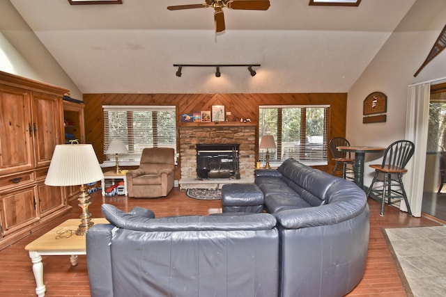 248 Miller Dr, Pocono Pines, PA 18350 - living room featuring vaulted ceiling, wood finished floors, wooden walls, and rail lighting