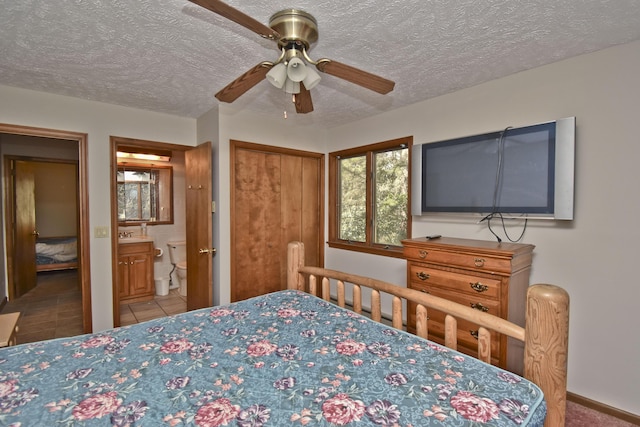 248 Miller Dr, Pocono Pines, PA 18350 - bedroom with tile patterned flooring, a ceiling fan, connected bathroom, and a textured ceiling