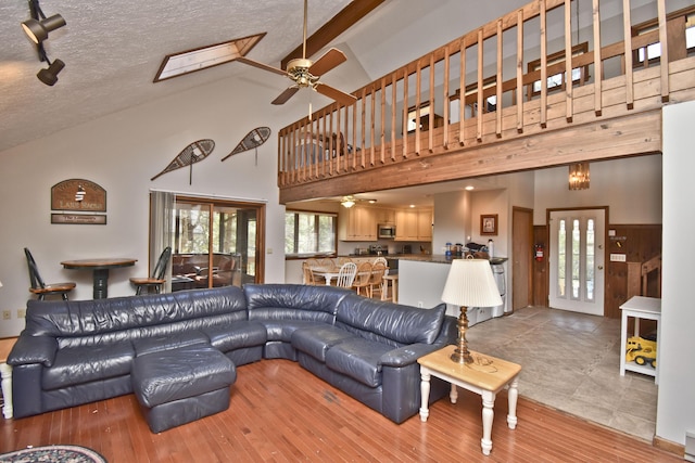 248 Miller Dr, Pocono Pines, PA 18350 - living area with wood finished floors, high vaulted ceiling, and ceiling fan