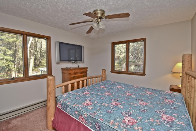 248 Miller Dr, Pocono Pines, PA 18350 - carpeted bedroom with baseboard heating, a ceiling fan, multiple windows, and a textured ceiling