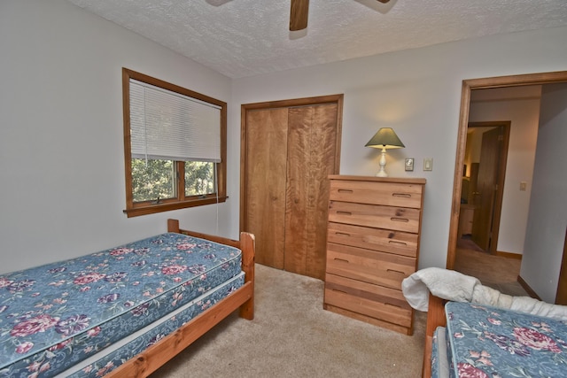 248 Miller Dr, Pocono Pines, PA 18350 - bedroom featuring a closet, a textured ceiling, carpet flooring, and ceiling fan