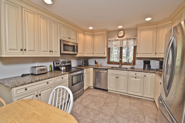 248 Miller Dr, Pocono Pines, PA 18350 - kitchen with stainless steel appliances, a sink, recessed lighting, light tile patterned floors, and cream cabinets