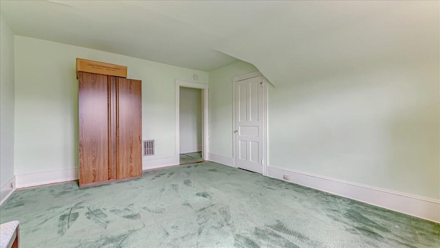 unfurnished bedroom featuring visible vents, baseboards, and carpet