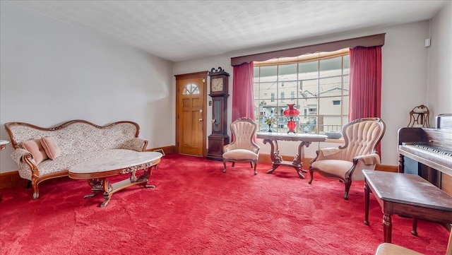 sitting room featuring carpet and baseboards