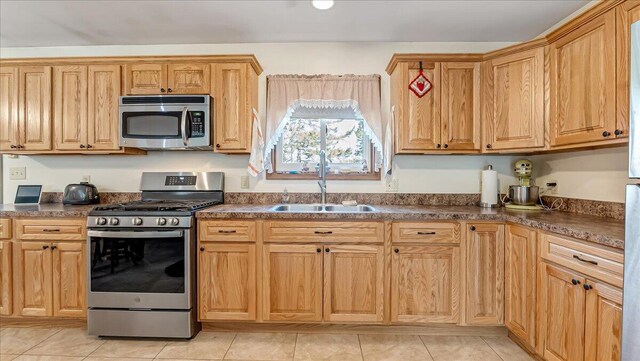 205 Flatbrook Way, Milford, PA 18337 - kitchen featuring appliances with stainless steel finishes, light tile patterned floors, dark countertops, and a sink