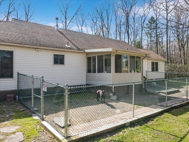 205 Flatbrook Way, Milford, PA 18337 - rear view of house with a sunroom, a shingled roof, a fenced backyard, and a gate