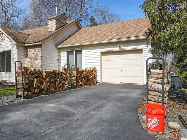 205 Flatbrook Way, Milford, PA 18337 - view of property exterior featuring a garage, a chimney, a shingled roof, and aphalt driveway