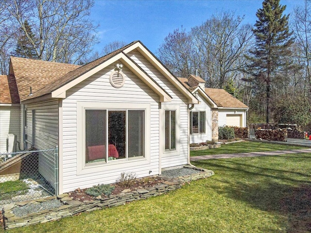 205 Flatbrook Way, Milford, PA 18337 - exterior space featuring fence, a yard, a shingled roof, and an attached garage