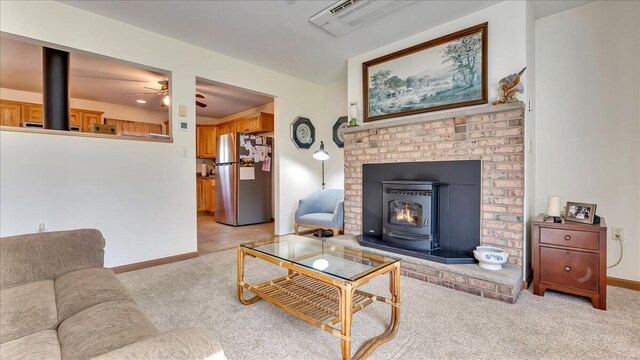 205 Flatbrook Way, Milford, PA 18337 - living area with visible vents, a wood stove, light colored carpet, and baseboards