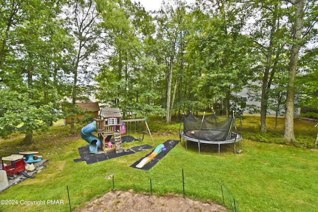 view of jungle gym featuring a trampoline and a lawn