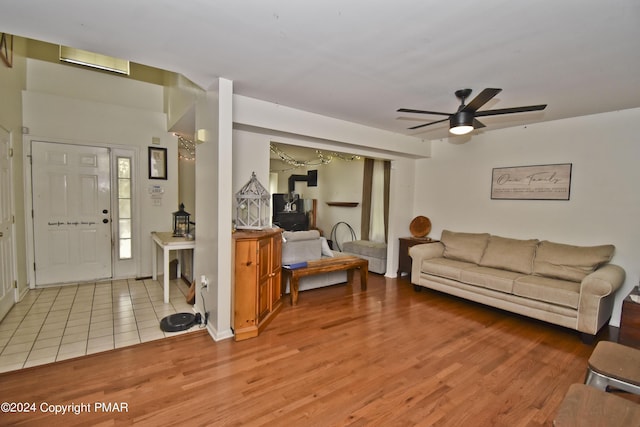 living room with a ceiling fan and wood finished floors