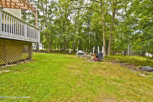 view of yard featuring a deck and a pergola