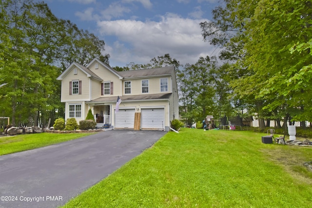 view of front of house with driveway, a garage, and a front yard