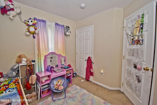 rec room with carpet floors, ornamental molding, and baseboards