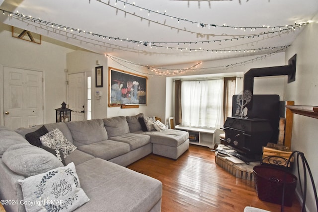 living room with a wood stove and hardwood / wood-style flooring