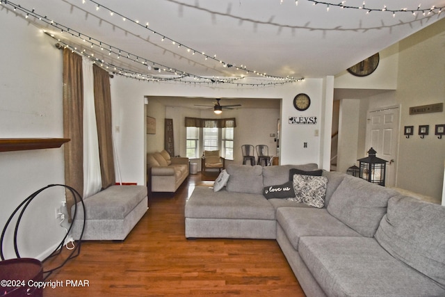 living room with stairs, rail lighting, and wood finished floors