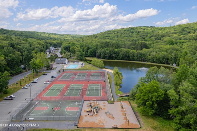 bird's eye view featuring a water view and a view of trees