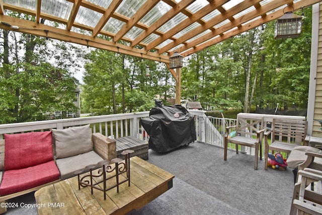 deck featuring grilling area and a pergola