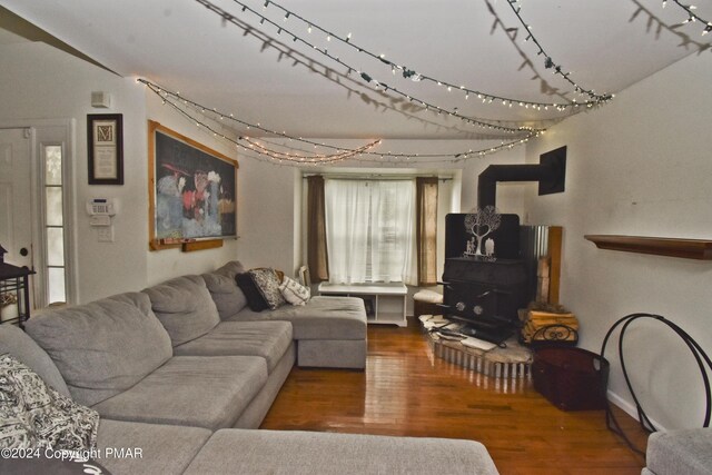 living room with wood-type flooring and a wood stove