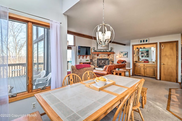 296 Overlook Way, Tannersville, PA 18372 - dining area with an inviting chandelier, a stone fireplace, and light colored carpet