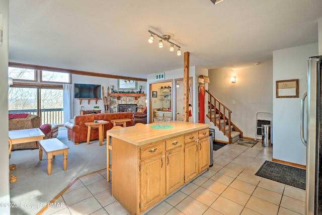 296 Overlook Way, Tannersville, PA 18372 - kitchen featuring a stone fireplace, freestanding refrigerator, open floor plan, light tile patterned floors, and visible vents