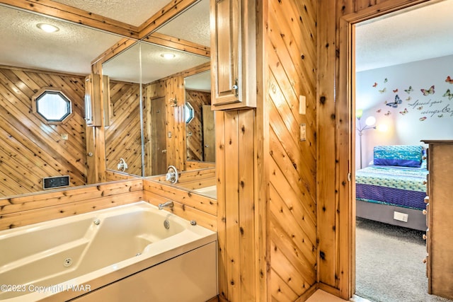 296 Overlook Way, Tannersville, PA 18372 - ensuite bathroom featuring a jetted tub, ensuite bath, wood walls, and a textured ceiling